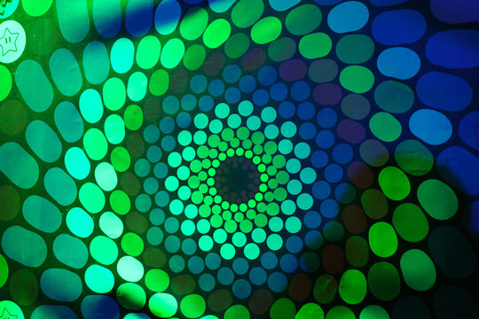 Spinning RGB colored hallucination on a wall