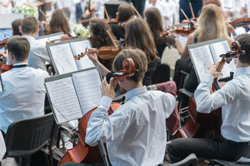 Men with a cello in an orchestra.