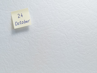 October 24. Calendar date on a yellow sticky note with copy space on white background.