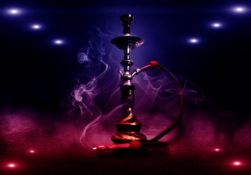 Hookah smoking on a dark concrete background, neon light, smog, night, rays