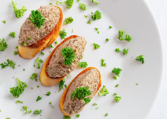 toasts with forest mushrooms spread decorated with parsley
