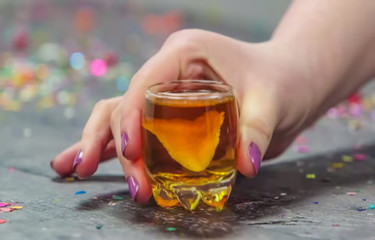 Abstract, blur, bokeh background, defocusing - image for the background. Whiskey with lemon