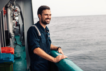 Marine Deck Officer or Chief mate on deck of vessel or ship . Marine life. He is smiling © Igor Kardasov