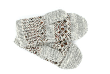Warm wool gray mittens with a pattern is on a white background