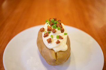 Steamed potato with sour white cream on top
