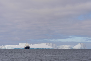 Expedition ship with iceberg in Antarctic sea
