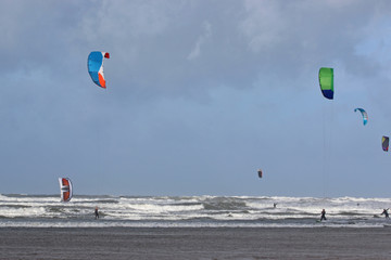 kitesurfers riding the waves