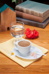 turkish dibek coffe and delights on white plate with books on wooden table