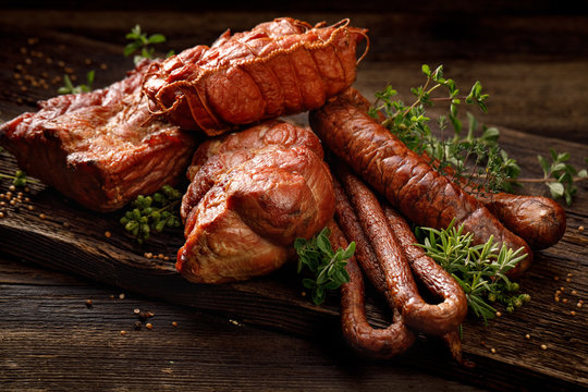 Smoked meats and sausages. A set of traditional smoked meats and sausages: ham,gammon, pork loin, home-style sausages, kabanosy. Traditional meats and sausages smoked in apple, beech and juniper wood 