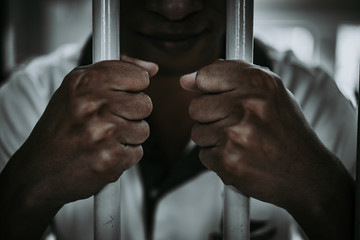 Hands of men desperate to catch the iron prison,prisoner concept,thailand people,Hope to be free.