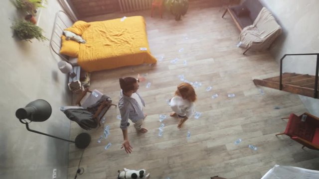 Happy young couple throws money up.Business team parter celebrating profit by throwing money. I am rich.