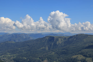 Closeup view mountains and valley scenes in national park Dombai, Caucasus, Russia, Europe. Summer landscape, sunshine weather, dramatic blue sky and sunny day