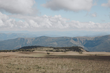 Closeup view mountains and valley scenes in national park Dombai, Caucasus, Russia, Europe. Summer landscape, sunshine weather, dramatic blue sky and sunny day