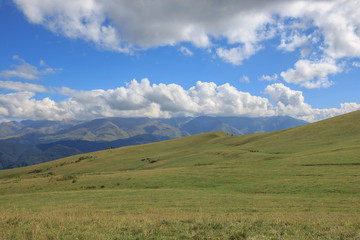 Closeup view mountains and valley scenes in national park Dombai, Caucasus, Russia, Europe. Summer landscape, sunshine weather, dramatic blue sky and sunny day