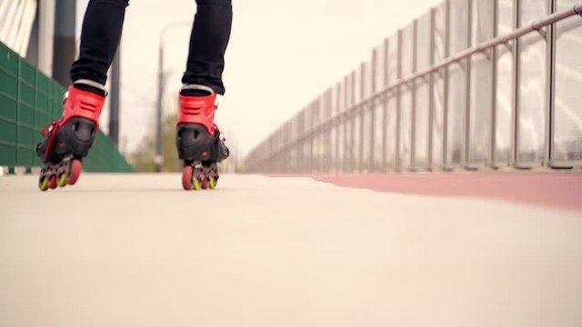 Young man in rollerblades riding in the city,focus on shoes, 120fps 
