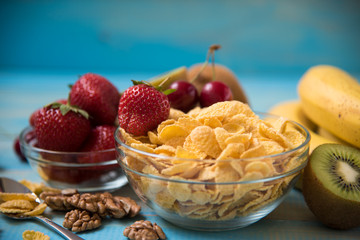 Tasty cornflakes witt walnut in glass bowl