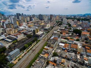 Fototapeta na wymiar Great cities, great avenues, houses and buildings. Light district (Bairro da Luz), Sao Paulo Brazil, South America. Rail and subway trains. Aerial view of State Avenue next to the Tamanduatei River 
