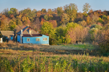 Small rustic home with adjoining vegetable garden in autumn time. Rural life. Ukraine.