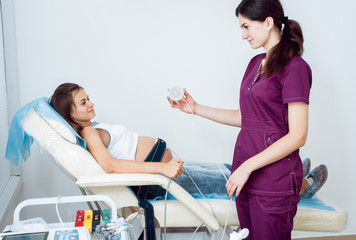 Pregnant woman with electrocardiograph check up for her baby. Fetal heart monitoring