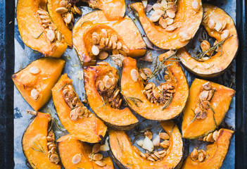 Pumpkin baked with herbs in tray.Roasted autumn vegetables healthy food.