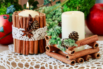 Candle decorated with cinnamon sticks