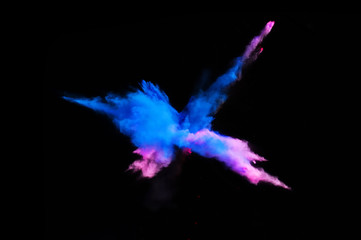 Fantastic forms of powder paint and flour combined  together explode in front of a black background...