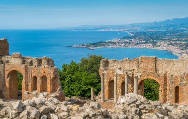 Ruins of the Ancient Greek Theater in Taormina with the sicilian coastline. Province of Messina,...