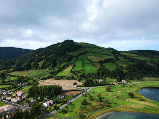 Fototapeta na wymiar Aerial View from a beautiful lagoon surrounded by mountains. Ancient volcano crater. Seven Cities lagoon Azores Islands Portugal
