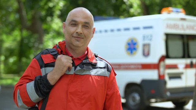 Middle-aged paramedic posing for camera, professional emergency medical service