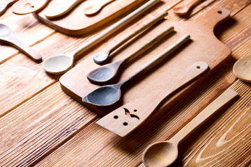 Wooden kitchen accessories on wood. Cutting boards and wooden spoons.