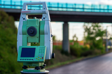 Surveyor equipment (theodolit or total positioning station) on the construction site of the...