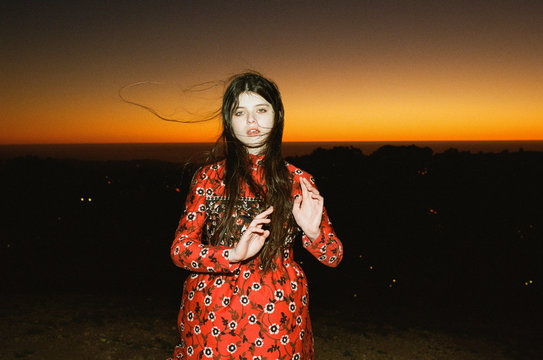 Woman poses during sunset