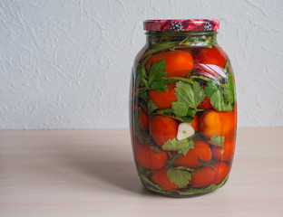Salted tomatoes in a glass jar. Home preservation.
