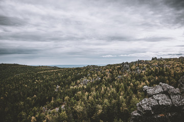 Closeup mountains scenes in national park Kachkanar, Russia, Europe. Cloudy weather, dramatic blue color sky, far away green trees. Colorful summer day