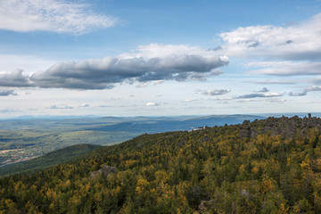 Closeup mountains scenes in national park Kachkanar, Russia, Europe. Cloudy weather, dramatic blue color sky, far away green trees. Colorful summer day