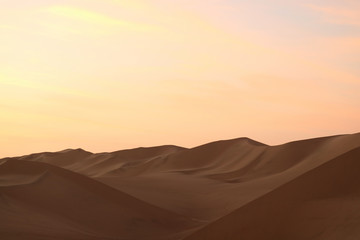 Fototapeta na wymiar Pastel color of sunset sky over the sand dune of Huacachina desert in Ica Region, Peru, South America 