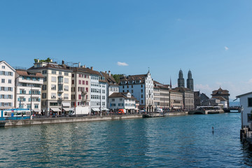Fototapeta na wymiar Zurich, Switzerland - June 19, 2017: Panoramic view of historic Zurich city center with famous Grossmunster Church and river Limmat. Summer day with blue sky