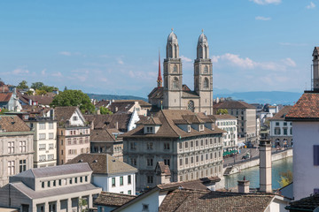 Fototapeta na wymiar Aerial view of historic Zurich city center with famous Grossmunster Church and river Limmat from Lindenhof park, Zurich, Switzerland. Summer landscape, sunshine weather, blue sky and sunny day