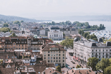 Fototapeta na wymiar Zurich, Switzerland - June 19, 2017: Aerial view of historic Zurich city center with Opera house and lake Zurich from Grossmunster Church, Switzerland. Sunny day in summer