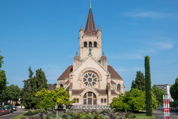 Fototapeta na wymiar Basel, Switzerland - June 20, 2017: View on St. Paul's Church (Pauluskirche), part of the Evangelical-Reformed Church of the Canton Basel. Summer day with blue sky
