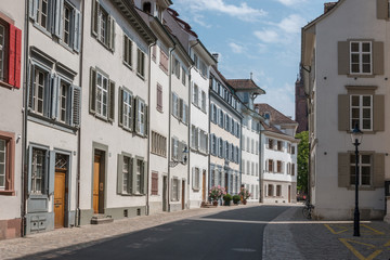 Fototapeta na wymiar Basel, Switzerland - June 19, 2017: Walk through old buildings in historic center of Basel city. Summer day with blue sky