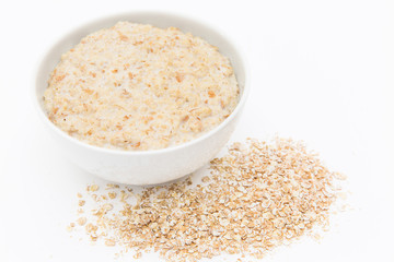 Oatmeal in white bowl on white background. Isolated on white. Healthy food