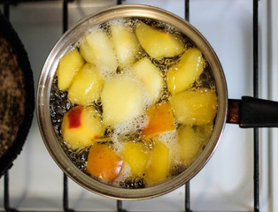 Apple compote is cooked in a saucepan