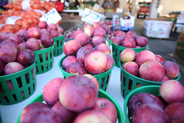  lots of red apples in baskets at the farmers market