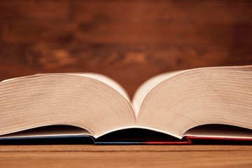 open book pages close-up selective focus on wooden background