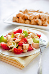 Salad with three kinds of tomatoes, boiled white kidney beans and croutons from white bread