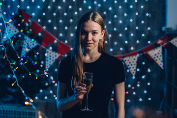Young woman with glass of champagne. New Year, Christmas