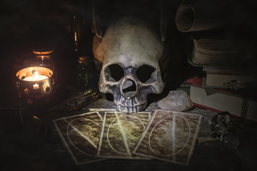 Tarot cards and book of magic on fortune teller table background. Futune reading concept.