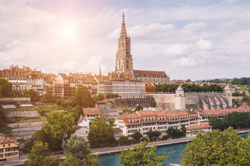 Fototapeta na wymiar Panoramic view on Bern Minster and historic old town of Bern, capital of Switzerland, Europe. Summer landscape, sunny day and blue sky