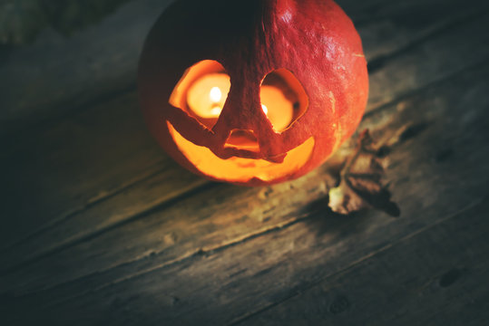 Halloween pumpkin head jack leaves wooden